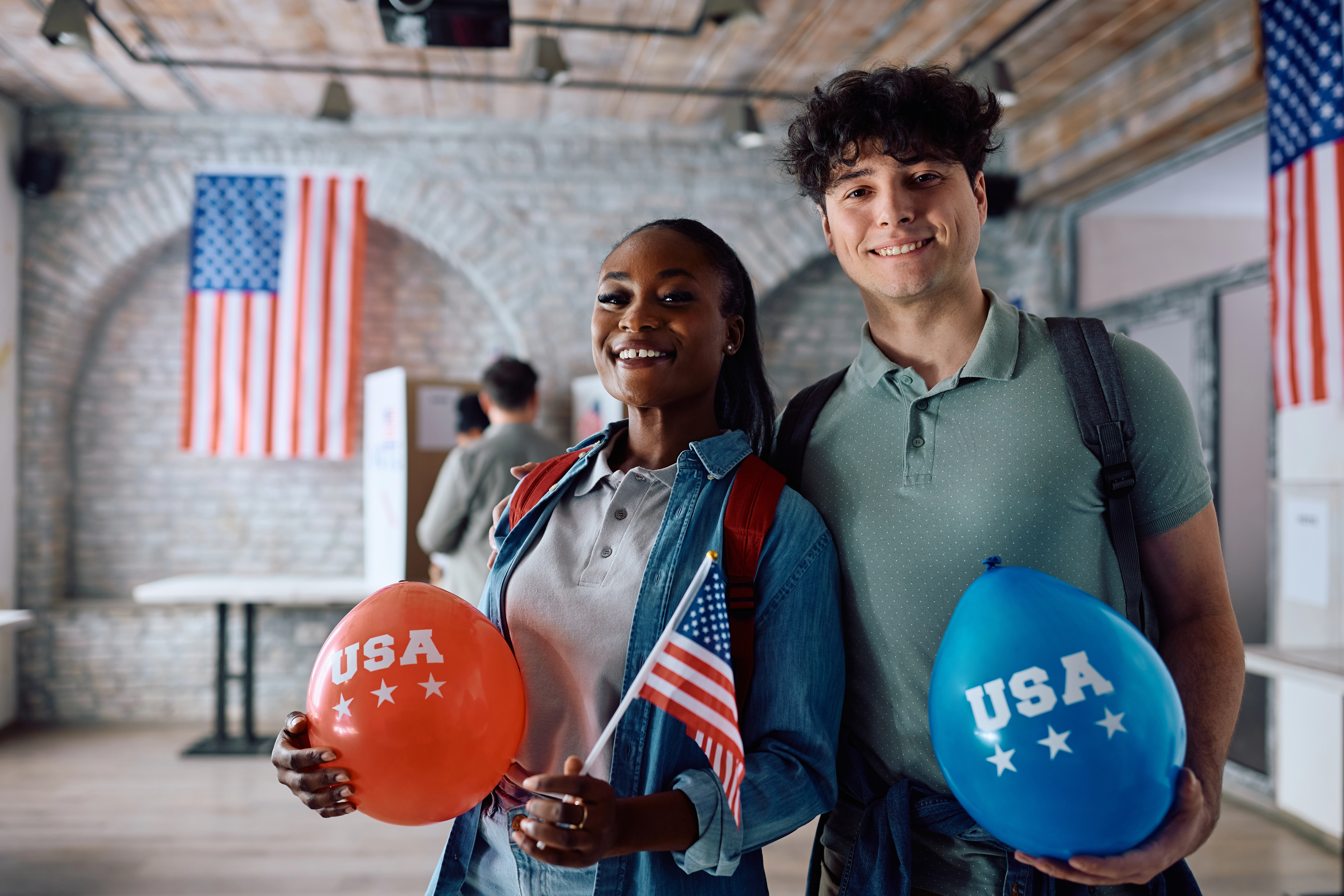 Smiling people holding USA balloons